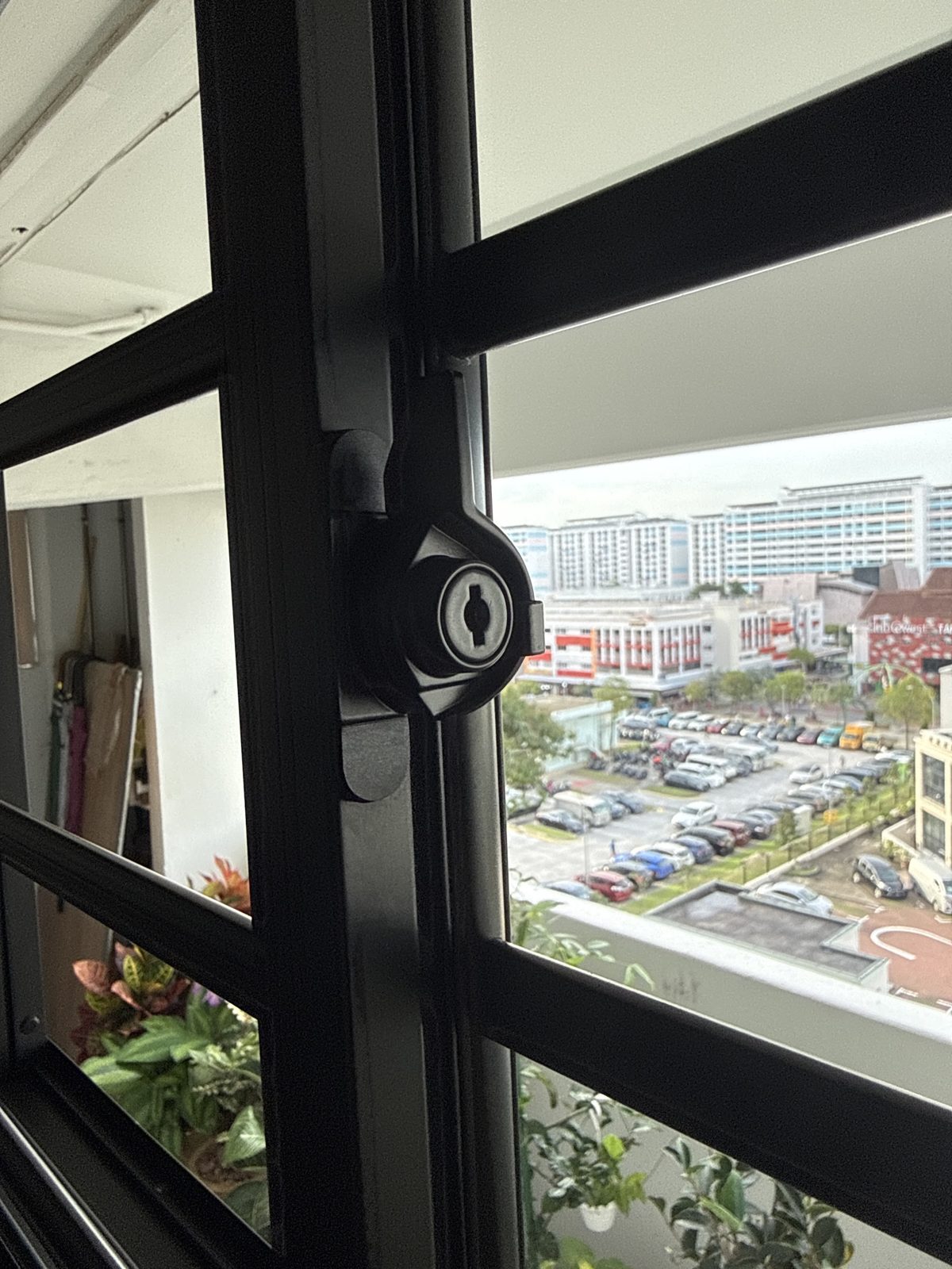 A new window grill lock fitted to a black aluminium frame